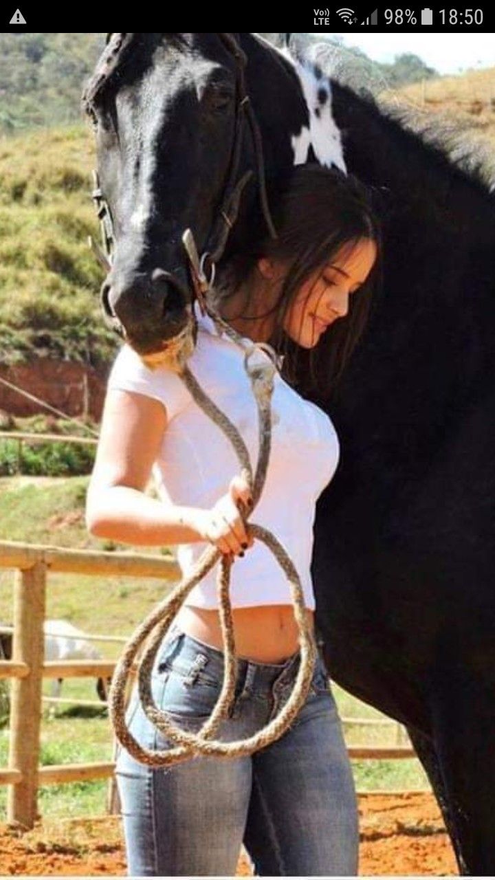 A woman and her horse pose together.
