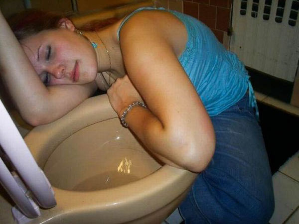 A woman having a wild weekend, caught sleeping on a toilet.