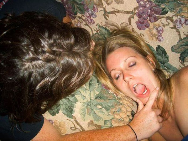 A woman is laying on a couch with her mouth open as the girls got a bit wild this weekend.