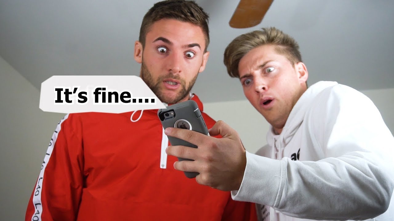 Two men capturing a selfie with the text "fine".