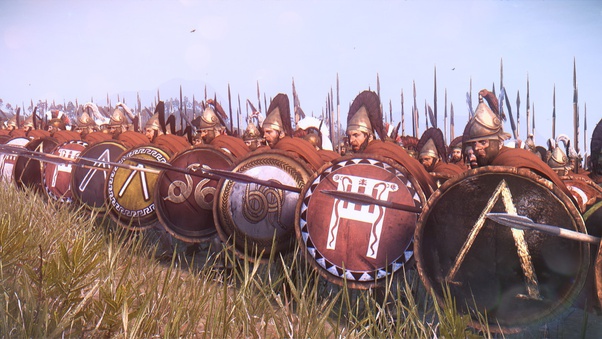 A group of shield-bearing warriors in a field.