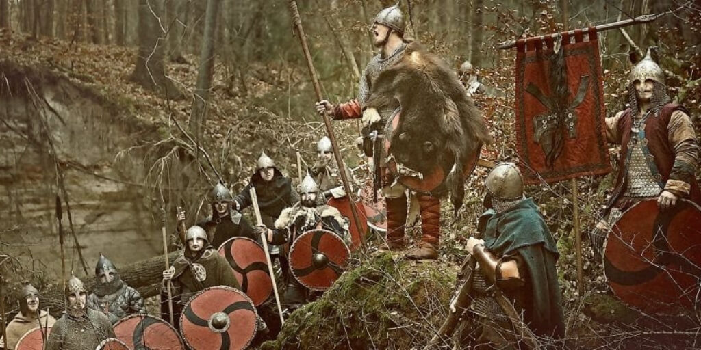 A group of vikings, part of one of the greatest warrior cultures in history, standing in a wooded area.