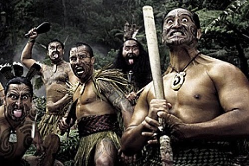 A group of men representing Aotearoa, showcasing traditional warrior outfits.