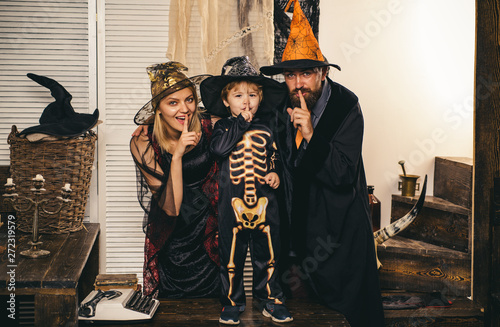 A family dressed up in Halloween costumes - premium photo capturing the essence of All Hallows Eve.