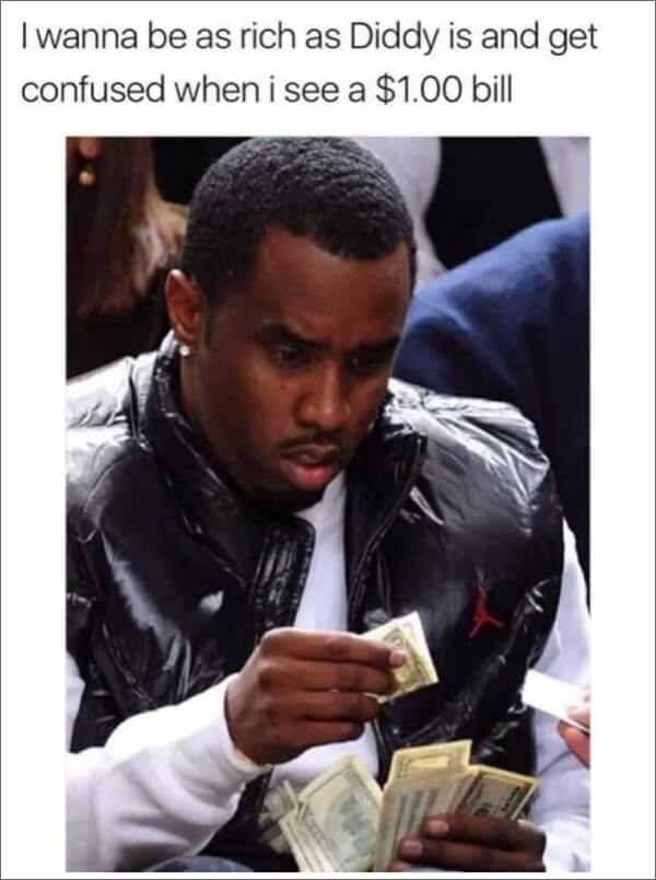 A man is holding a $100 bill in his hand.