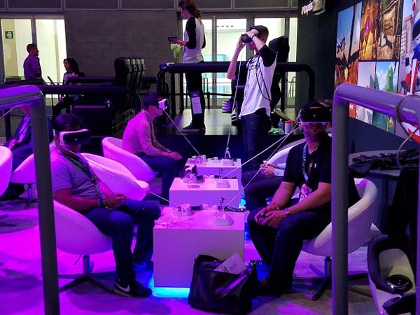 A group of people sitting in chairs with virtual reality headsets.