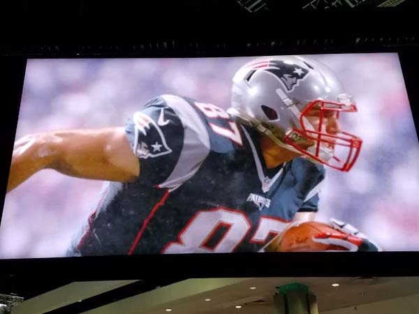 An image of a football player on a large screen.